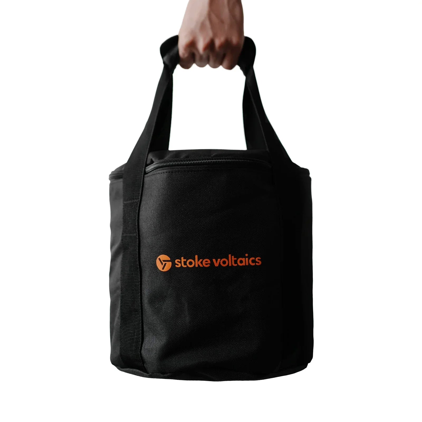 Hand holding black Stoke Voltaics carrying bag with orange logo, ideal for outdoor gear.