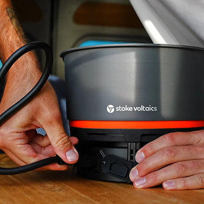 Stoke Voltaics all-purpose kettle pot being set up on a wooden surface for outdoor cooking
